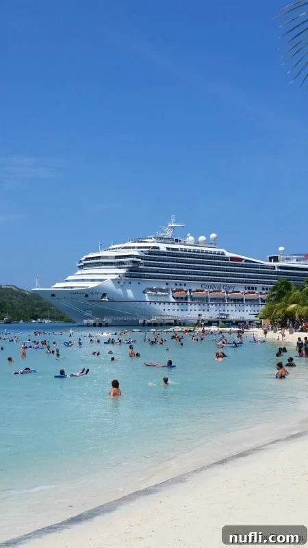 Mahogany Bay Roatan Cruise Adventure 8 Carnival cruise ship in the background of people playing at the beach and in the water.