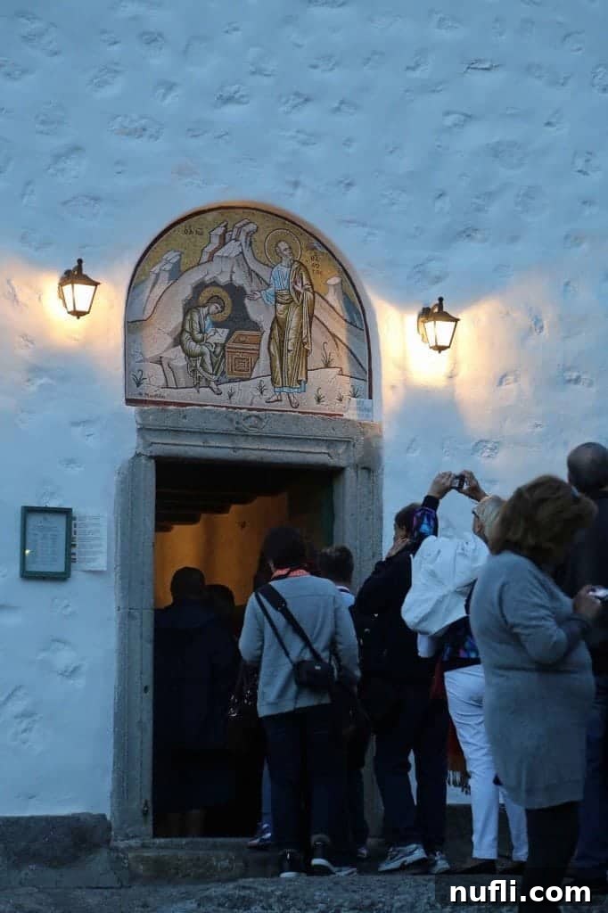Patmos: St. John's Monastery and the Cave of Apocalypse 4 People entering a historic church in Patmos, Greece, showcasing traditional architecture