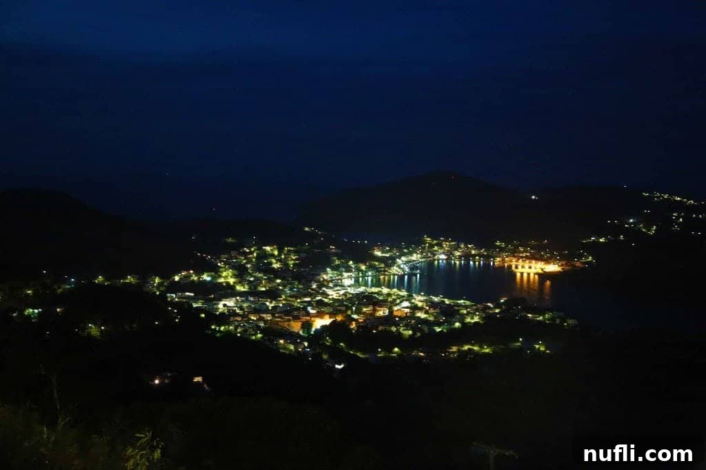 Patmos: St. John's Monastery and the Cave of Apocalypse 9 The charming town of Patmos, Greece illuminated at night with lights reflecting on the water