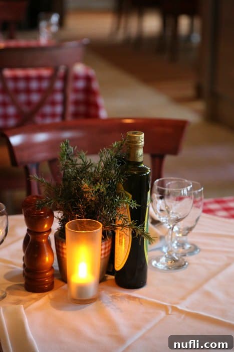 Carnival Sunshine Dining Guide 4 Table with rosemary, olive oil, wine glasses, and a flameless candle