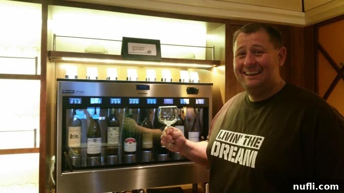 Carnival Sunshine Things We Absolutely Love 6 John holding a glass of wine by a wine dispenser