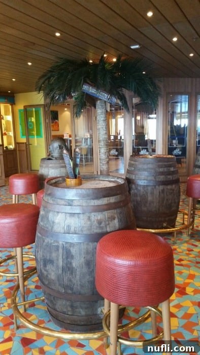 Carnival Sunshine Things We Absolutely Love 7 barrels with red stools and a fake palm tree in Red Frog Pub