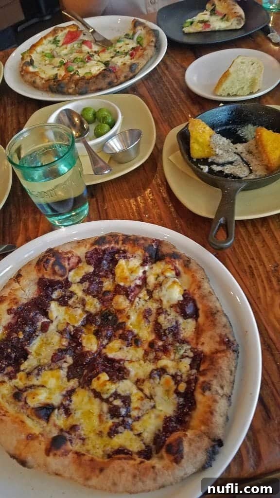 A table at Campo Reno, Nevada, beautifully set with a delicious pizza and a sizzling skillet