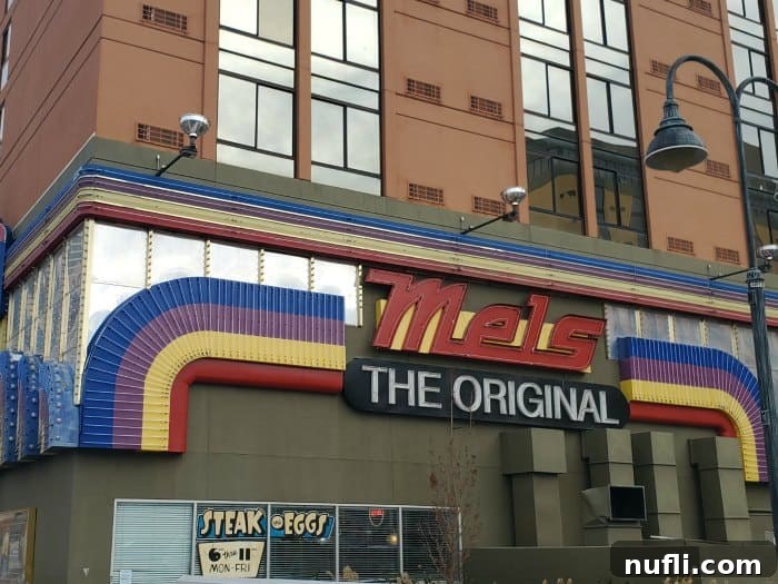 Original Mel's Diner sign featuring a rainbow alongside a building in Reno