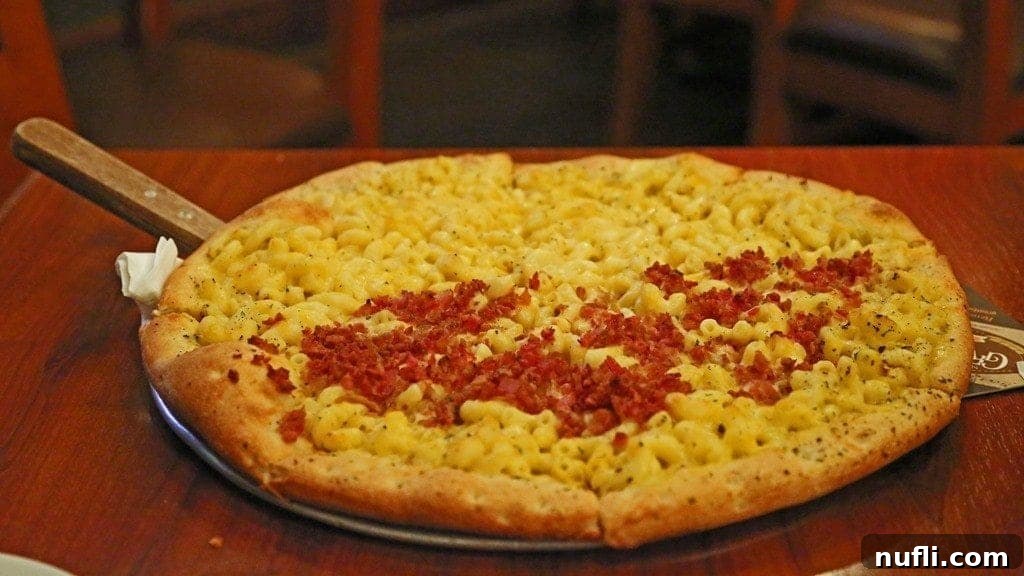 A delectable mac and cheese pizza served on a rustic platter