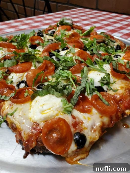 pizza with tomatoes, basil, and olives