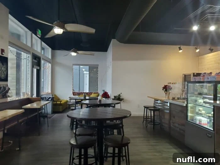 Inviting coffee shop interior with a tempting bakery case, comfortable tables, and chairs