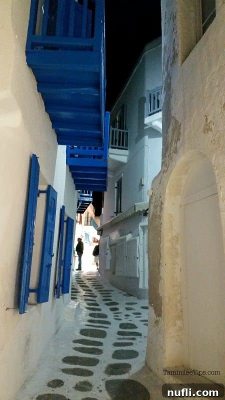 pathway through white and blue buildings 