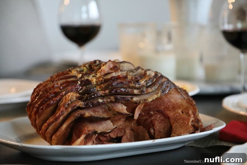 Crockpot Coca-Cola Ham Recipe 3 Close-up of a succulent crockpot coke ham on a white platter, ready to be served