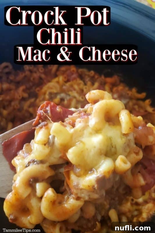 Crock pot chili mac & cheese over a slow cooker with a scoop of chili mac on a spoon