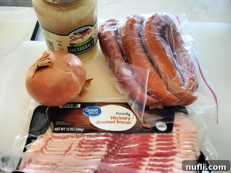 Sauerkraut and pork ingredients, sauerkraut, kielbasa, onion, and bacon on a kitchen counter