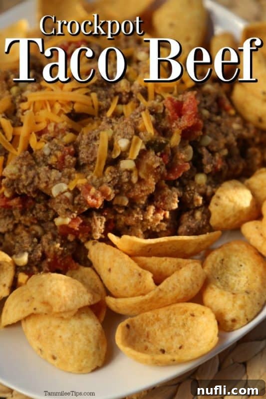 Delicious Crockpot Taco Beef served over a plate of beef and cheese, ready for toppings