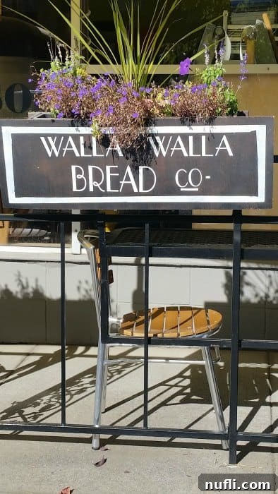 Walla Walla's Culinary Gems: Essential Dining Experiences 4 Walla walla bread co sign on a fence next to a chair and flowers