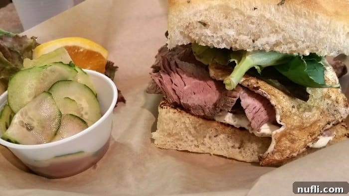 Walla Walla's Culinary Gems: Essential Dining Experiences 5 roast beef sandwich and cucumber salad on a parchment paper lined plate