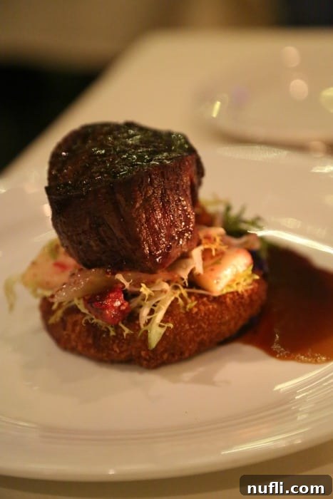 Butchart Gardens Victoria BC: Enchanting Holiday Illuminations 5 Gourmet steak dish on a plate, accompanied by a delectable Gruyère mac and cheese fritter, roasted vegetables, and rich demi-glace