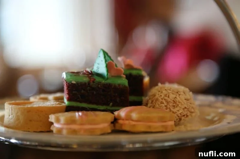 An enticing assortment of finely crafted desserts, including cakes and tarts, presented on a tea plate.