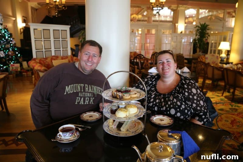 A couple, Tammilee and John, smiling while enjoying their tea experience at the Fairmont Empress.
