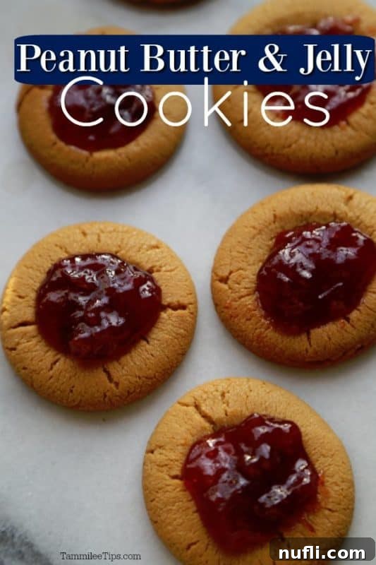 PB&J Stuffed Delights 2 Peanut Butter and Jelly Cookies text over parchment lined baking sheet with cookies