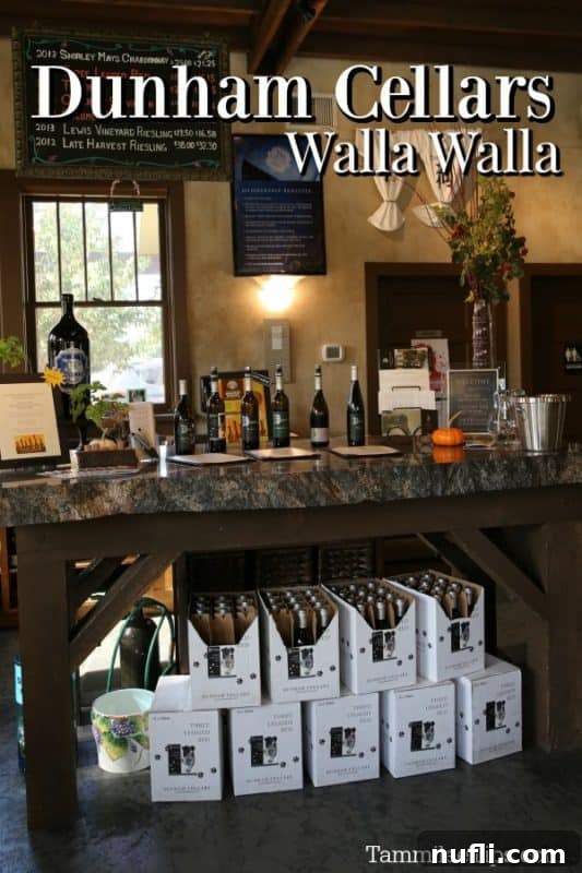 Dunham Cellars Walla Walla over a display of wine bottles 