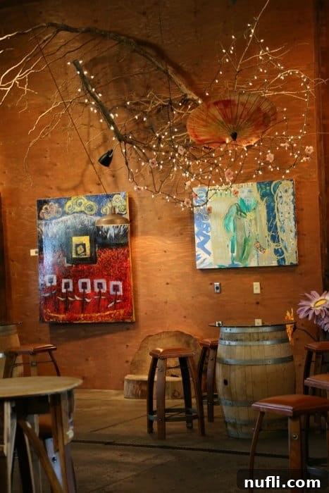 art on the wall above a wine barrel table