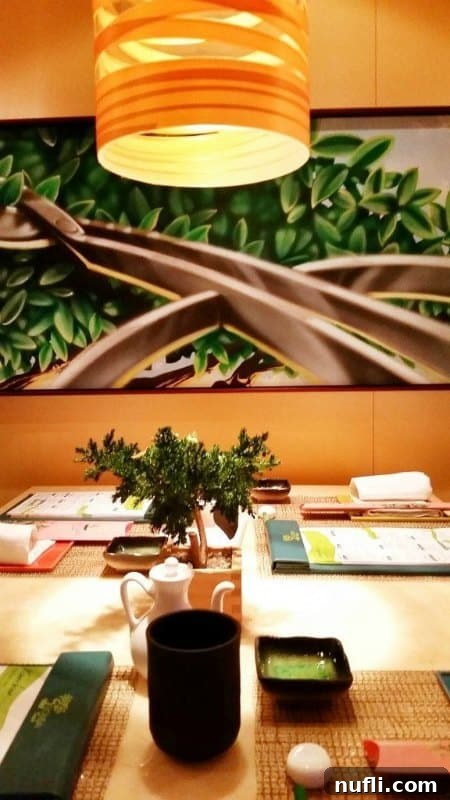 Bonsai Sushi table with small plant, menu, and greenery