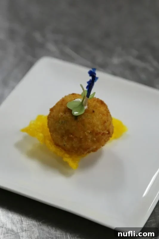 Carnival Sunshine's Exclusive Chef's Table 6 Vibrant mango spheres delicately placed on rosemary biscuits, a sweet and savory appetizer