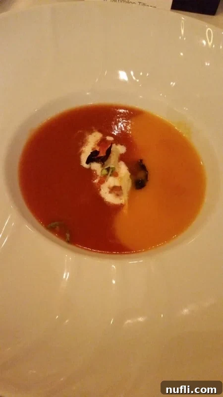 Carnival Sunshine's Exclusive Chef's Table 8 Two distinct types of bisque, beautifully presented side-by-side in a pristine white bowl, showcasing culinary artistry