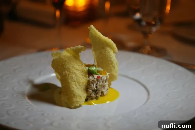 Carnival Sunshine's Exclusive Chef's Table 9 A gorgeously plated dish, featuring vibrant colors and intricate textures, characteristic of gourmet dining