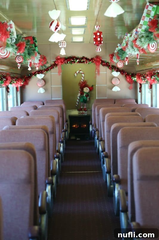 Experience vintage charm and festive decor inside a Branson Scenic Railway car. Interior of Branson Scenic Railway car decorated for Christmas with festive garlands and comfortable seating