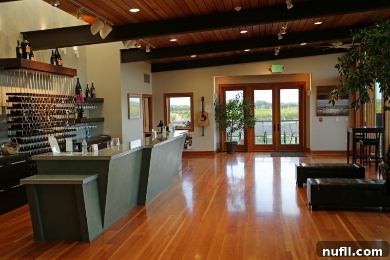 The sophisticated interior of Amavi Cellars, featuring a sleek tasting counter, artfully arranged racks of wine, and comfortable seating areas
