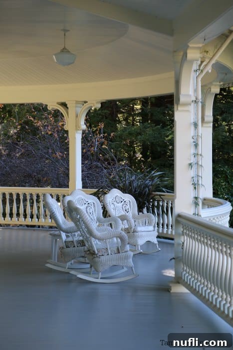 A close-up view of the spacious front porch of the Main House, adorned with ornate rocking chairs, inviting relaxation and offering panoramic views over the expansive Skywalker Ranch.