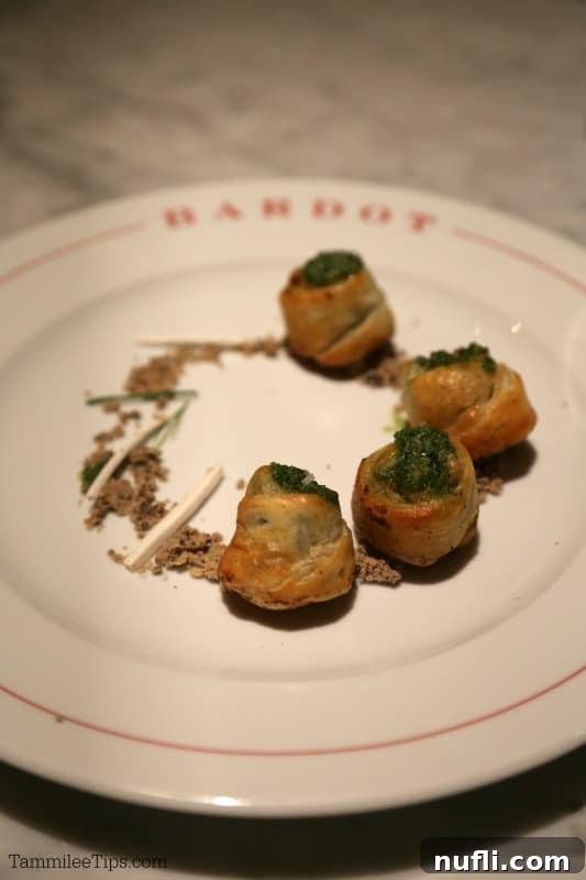 Bardot Brasserie at Aria: An Epicurean Revelation 6 Escargot served elegantly on a Bardot plate, garnished with fresh herbs.