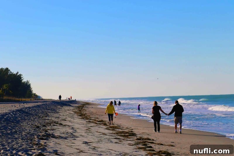 Sanibel Island: Florida's Picture-Perfect Escape 11 People walking the beach and looking for shells at sunset