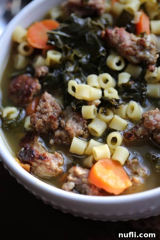 Close-up of Crock Pot Italian Sausage Wedding Soup Recipe ingredients being prepared, showcasing fresh vegetables like carrots and red onion.