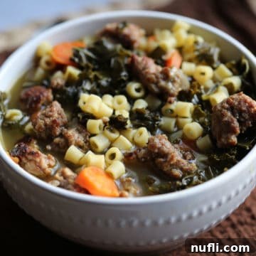 Crockpot Italian Wedding Soup in a white bowl on a brown cloth napkin