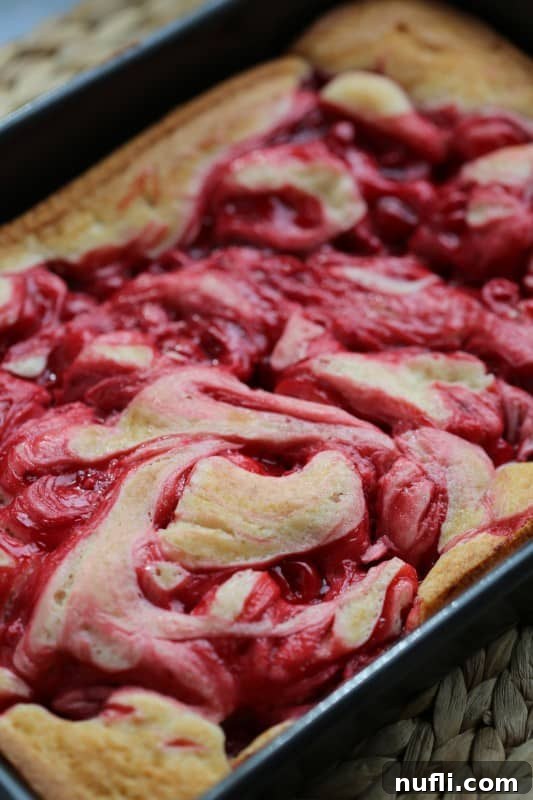 Marbled Cherry Pie Cake Recipe 5 A large rectangular Marbled Cherry Pie Cake, showing its full top surface with beautiful, intricate cherry swirls, ready to be served.