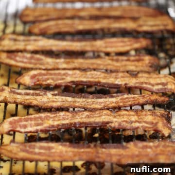 How to Make Brown Sugar Bacon Candy Video 2 Strips of brown sugar bacon candy on a wire rack