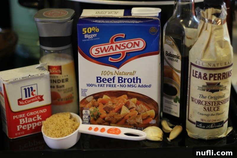 Ingredients for Balsamic French Dip: black pepper, salt, beef broth, balsamic vinegar, and Worcestershire sauce laid out in front of a modern slow cooker.