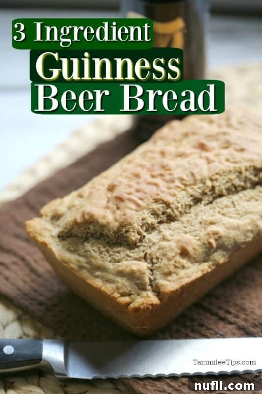Freshly baked Guinness Beer Bread with a knife next to it on a rustic brown placemat, ready to be sliced and served.