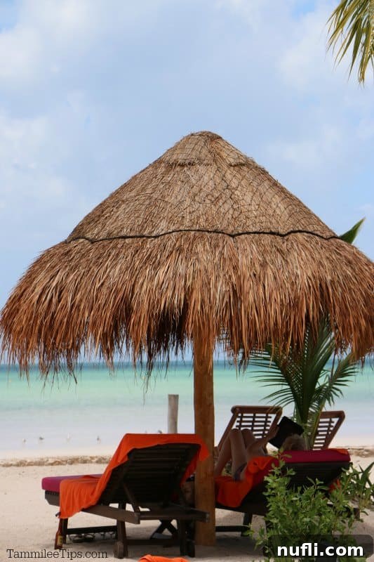 An Idyllic Photo Journey Isla Holbox Mexico 13 Thatched palapa over beach chairs with a person reading