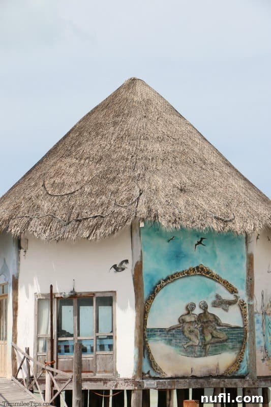 Capturing the Magic of Isla Holbox Mexico 6 Mural on the side of a thatched roof building