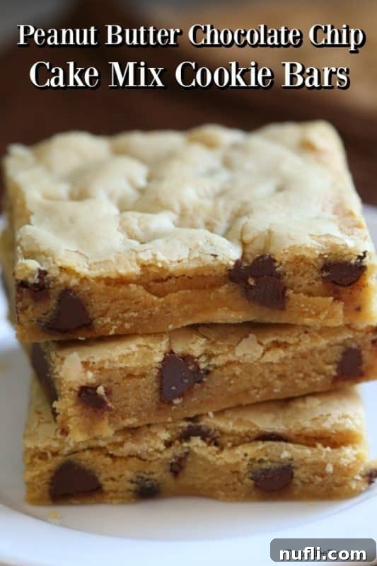 Stacked Chocolate Peanut Butter Cake Mix Cookie Bars with melted chocolate chips visible, indicating their delicious gooey texture.