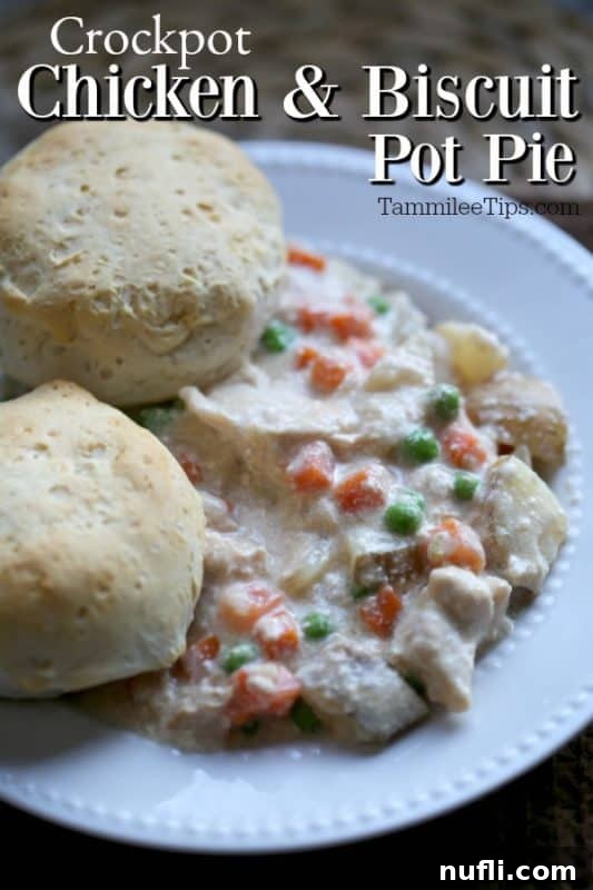Hearty Crockpot Chicken & Biscuit Pot Pie served in a white bowl with two golden biscuits