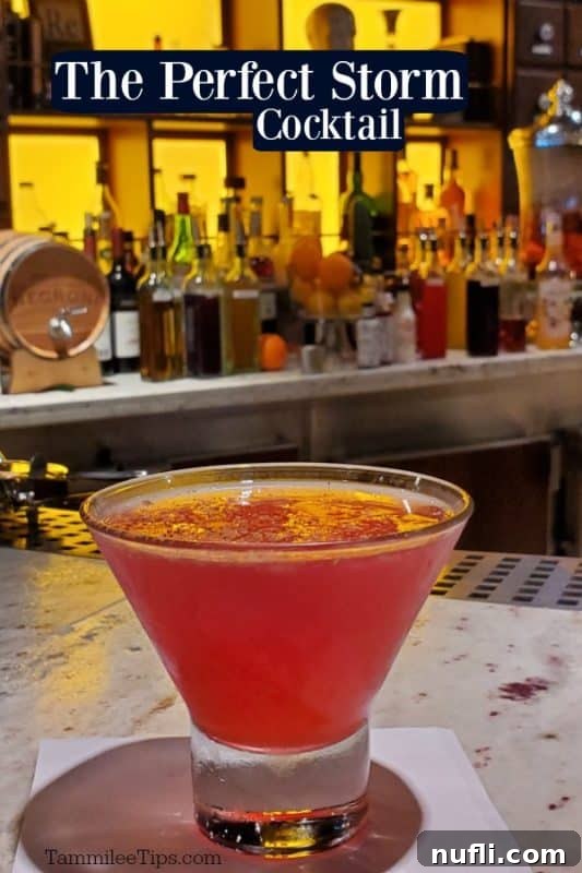 A vibrant pink cocktail in a glass, with the words 'The Perfect Storm Cocktail' printed over the image, evoking a sense of tropical indulgence.