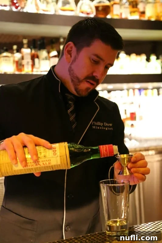 Aviation Cocktail: A Flight of Flavors 4 bartender pouring Luxardo liqueur in a jigger