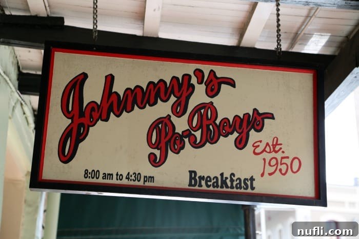 The classic exterior sign of Johnny's Po'Boys, established in 1950, a historic New Orleans eatery.