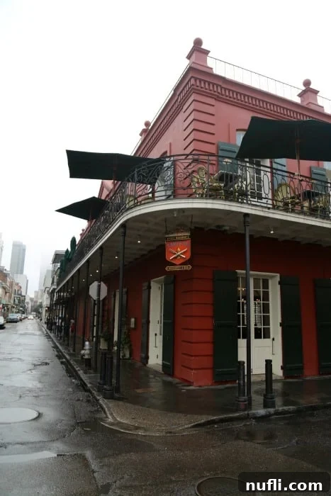 The elegant Tableau sign on a distinctive red building, seen from the bustling street near Jackson Square.