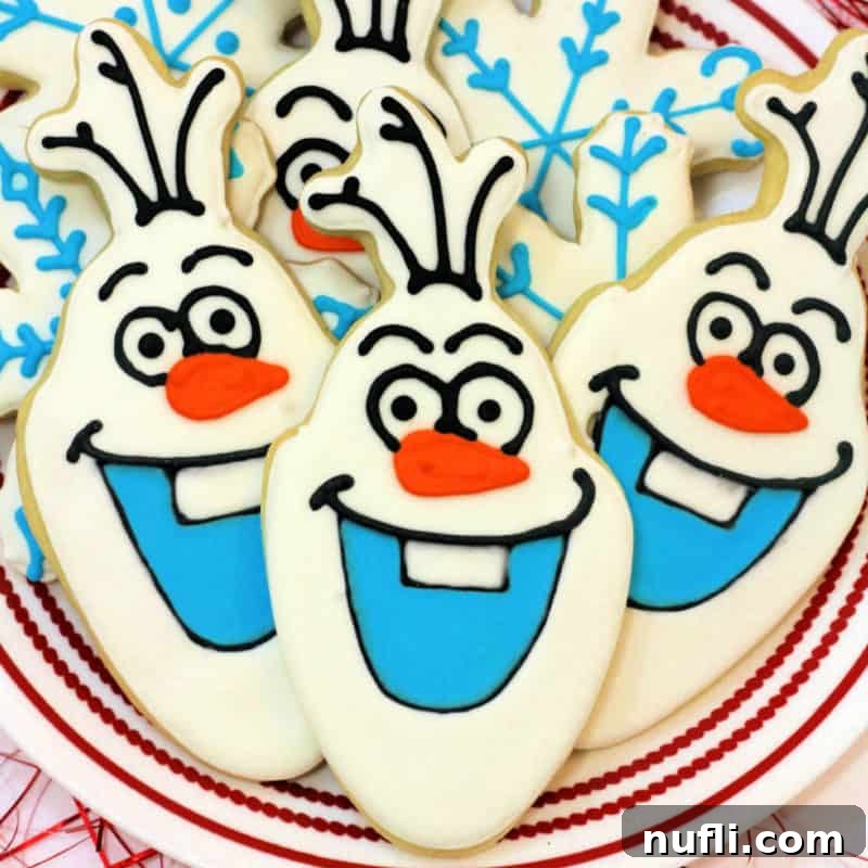 Olaf Cookies piled on a white plate, shaped like the Frozen character