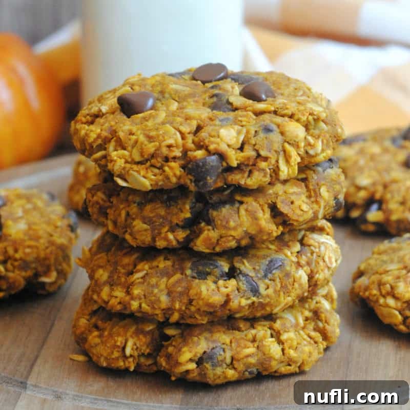 Stack of Pumpkin Oatmeal cookies on a rustic wooden board