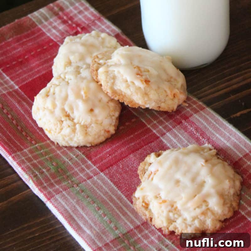 Apricot Cookies arranged on a red patterned napkin next to a glass of milk
